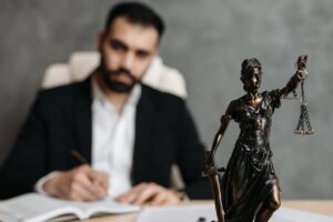 attorney looking at camera with lady justice in focus