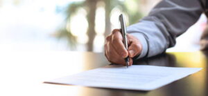 Person signing legal documents.
