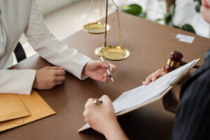 Lawyer explaining documents at a desk.