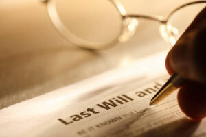Hand signing a last will and testament.