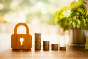Coins stacked with lock for asset protection.