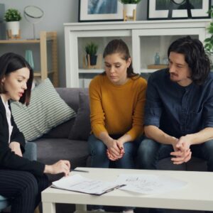 Couple reviewing documents with legal advisor at home