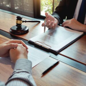 Lawyer discussing legal document beside gavel in office