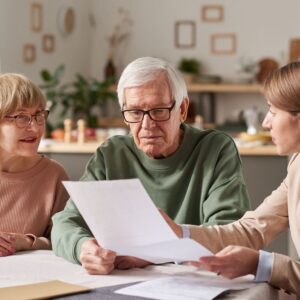 Elderly couple discussing documents with a lawyer