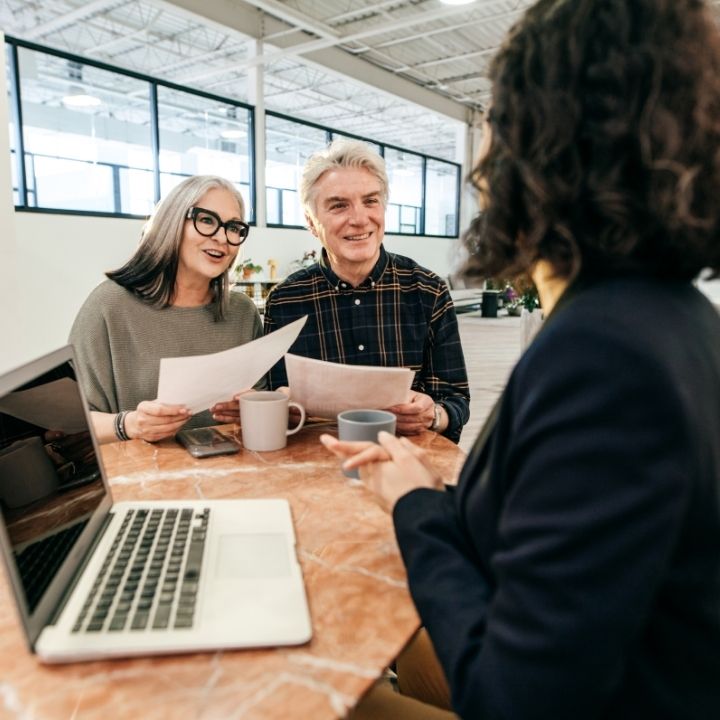 Senior couple discussing documents with a professional lawyer
